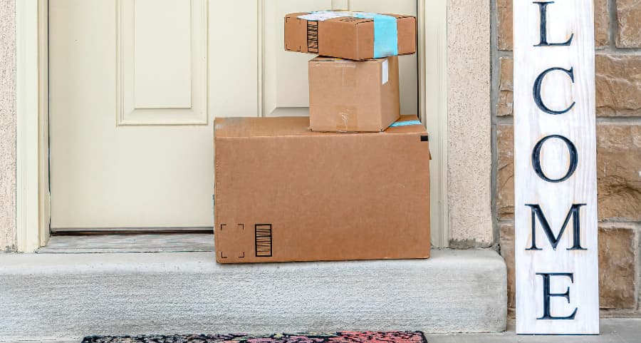 Boxes by the door of a residence with a welcome sign in Medford